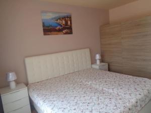 a bedroom with a bed and a painting on the wall at Home Relax Varna in Varna City