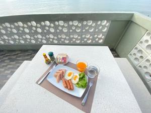 a plate of food with eggs and vegetables on a table at Phala Shore Resort 