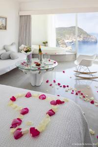 a living room with pink roses on the floor at Hacienda Na Xamena, Ibiza in Na Xamena