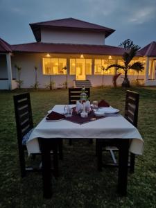 a table with a white table cloth on top of it at THE INFINITY PENCH RESORT in Khawāsa
