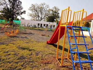 a group of playground equipment in a yard at THE INFINITY PENCH RESORT in Khawāsa