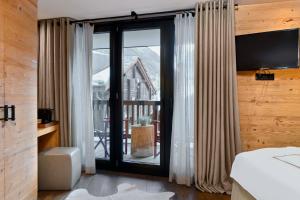 Postel nebo postele na pokoji v ubytování Unique Hotel Post
