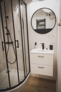 a bathroom with a shower and a sink and a mirror at Grzybowska Osada in Grzybowo +38 photos