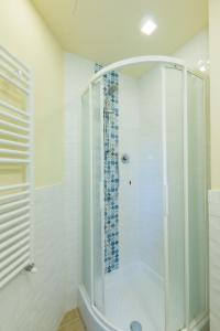 a shower with a glass door in a bathroom at Flat Volturno- Florentine neighbourhood in Florence