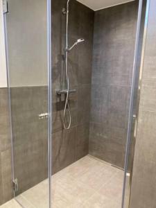 a shower with a glass door in a bathroom at stylish luxus appartments in the city center in Trier