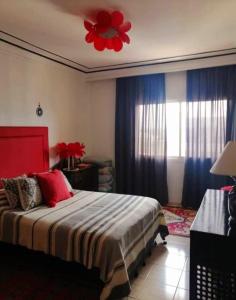 a bedroom with a bed with a red flower on the ceiling at Villa lumias in Marrakesh