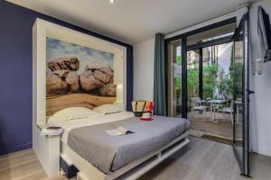 a bedroom with a bed with a painting on the wall at Belambra Clubs Presqu'île De Giens - Riviera Beach Club in Hyères