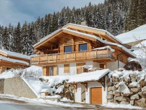 a log cabin in the snow with snow covered trees at Chalet La Clusaz, 7 pièces, 10 personnes - FR-1-304-282 in La Clusaz