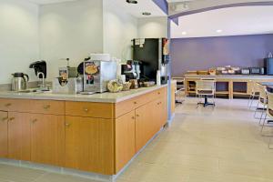 a large kitchen with a counter with a counter top at Microtel Inn & Suites by Wyndham Denver Airport in Denver