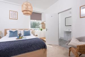 a bedroom with a bed and a bathroom at Keynvor Blue, Carbis Bay, St Ives in St Ives