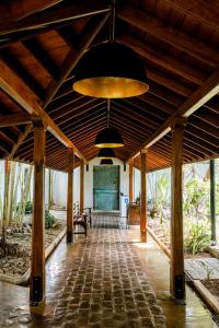 a large room with a ceiling with wooden beams at Villa Hundira in Negombo