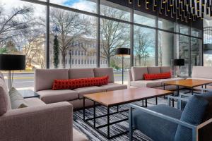 a lobby with couches and tables and windows at Hyatt Place Athens Downtown in Athens