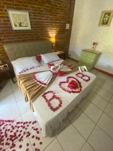 a bed in a bedroom with flowers on it at La Dolce Vita in Mulungu