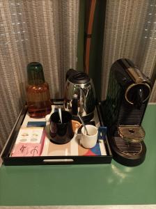 a tray with a coffee maker and cups on a table at B&B Via Diaz in Bergamo