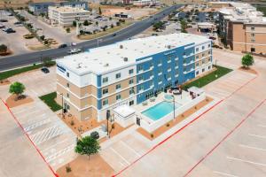 an aerial view of a building with a pool at AmericInn by Wyndham San Angelo in San Angelo