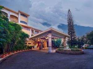 a large building with a pavilion in a courtyard at Fariyas Resort Lonavala in Lonavala
