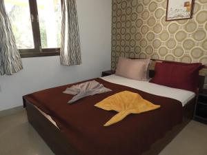 a bedroom with a bed with two towels on it at Services (Self Catering) Villas 8 and 9 in Anjuna +52 photos