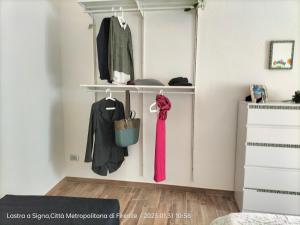 a bedroom with a white closet with a pink scarf at Al vecchio Mulino in Lastra a Signa