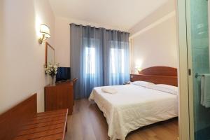 um quarto de hotel com uma cama e uma janela em Hotel Laura em Roma