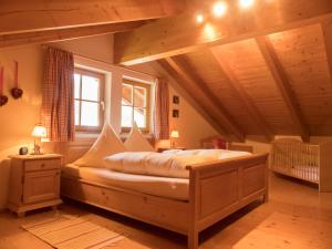 a bedroom with a large bed in a attic at Haus Alpenstern in Grainau