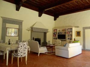 a living room with a table and chairs and a fireplace at Pian dei Giullari Suite in Florence