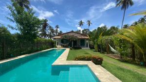 a swimming pool in front of a house at Kasa Karapató in Pôrto de Pedras