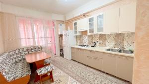 a kitchen with white cabinets and a sink at Apartament spatios in complex residential in Chişinău