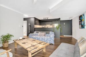 a living room with a table and a couch at Spacious 1 Bedroom Apartment near Newtown in Sydney