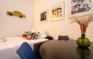 a room with a table and a yellow car on the wall at HSH Traversière Boulogne-Billancourt II Appartement 4P in Boulogne-Billancourt