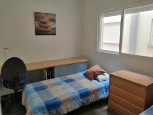 a bedroom with a bed and a desk and a chair at Apartamento Pepe in Alcantarilla