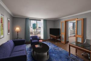 a living room with a blue couch and a table at Divan Ankara in Ankara