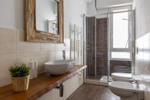 a bathroom with two toilets and a sink and a mirror at Largo Molina Studio II by Wonderful Italy in Bologna