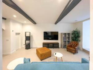 a living room with a blue couch and a tv at San Isidoro Coliving in Oviedo