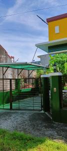 a bus stop with two trash cans next to a building at Tourist and Transient HOME. in Sorsogon