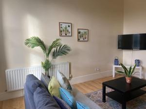 a living room with a couch and a table at Large Bright apartment in St. Leonards