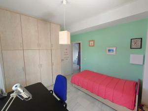 a bedroom with a pink bed and a blue wall at Greek Aesthetic Manor House in Nea Makri