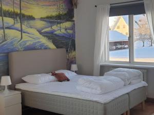 a bed with a teddy bear laying on top of it at Säfsen Stay in Ludvika