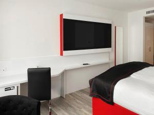 TV a/nebo společenská místnost v ubytování DORMERO Hotel Darmstadt