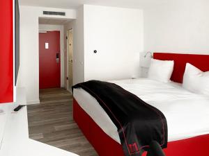 Postel nebo postele na pokoji v ubytování DORMERO Hotel Darmstadt