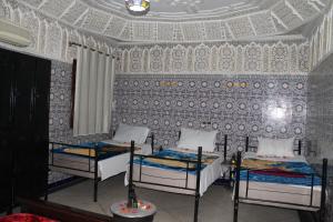 Postel nebo postele na pokoji v ubytování Riad Marrakech Medina