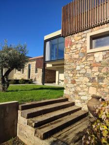 uma casa de pedra com uma escada que leva até ela em Raízes Turismo Rural em Castelo Branco