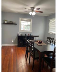 a dining room with a table and chairs and a ceiling fan at Spacious single family home close to VA and DC 5mins to MGM in Fort Washington