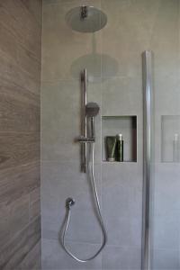 a shower with a shower head in a bathroom at Bed & Breakfast IL PAJO in Padenghe sul Garda