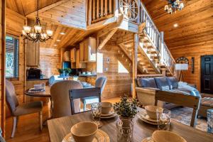 a dining room and living room in a log cabin at Pine Haven Hollow in Pigeon Forge