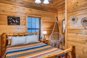 a bedroom with a bed in a log cabin at Pine Haven Hollow in Pigeon Forge
