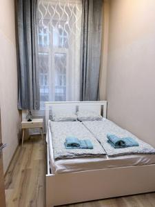 a bedroom with a bed with blue towels on it at Buda Castle Charming 2 bedrooms in Budapest