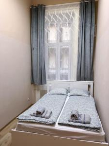 a bed in a room with a window at Buda Castle Charming 2 bedrooms in Budapest