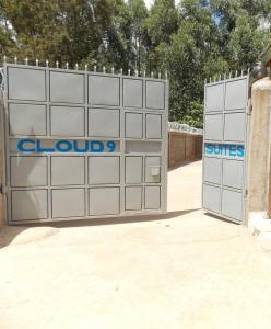 two garage doors with the words cluds and suites at Cloud9 Suites in Kitale