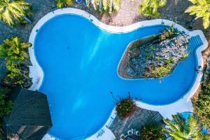an overhead view of a swimming pool at Diani Reef Beach Resort & Spa in Diani Beach