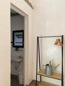 a room with a television and a table with a pot at MGM Ranch and Farm in Taal +18 photos
